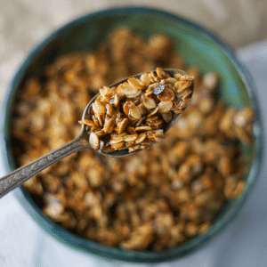 Close up photo of granola in a antique silver spoon.