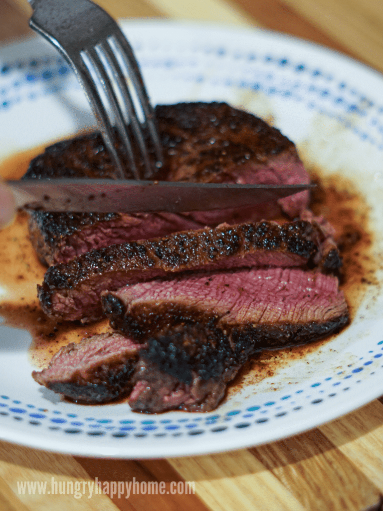 a grilled steak seasoned with the homemade steak seasoning and being sliced