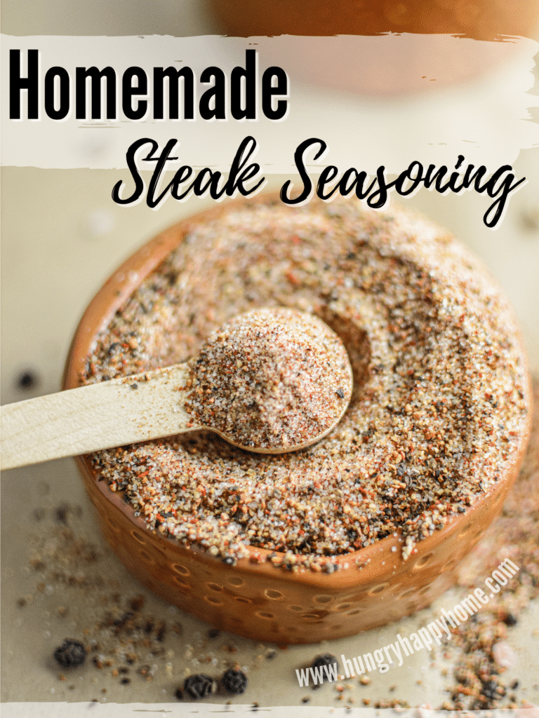 homemade steak seasoning: chili steak rub in a small clay bowl with a wooden spoon