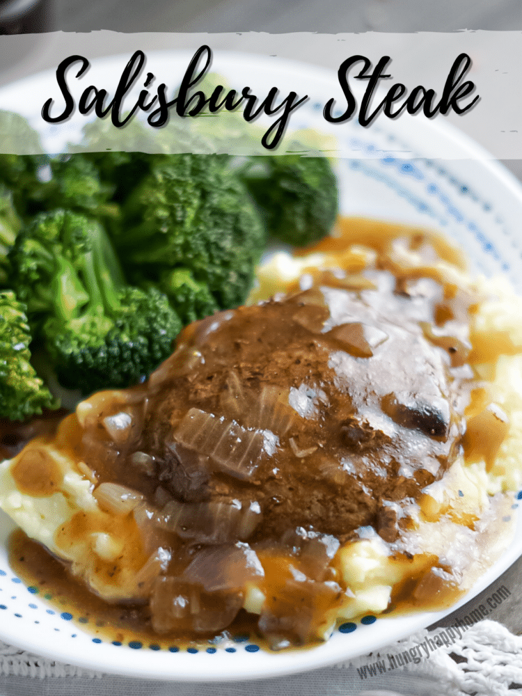 Salisbury Steak on top of mashed potatoes and covered in onion gravy.