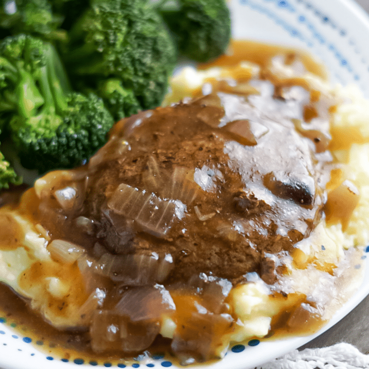 Salisbury steak on mashed potatoes and covered in gravy