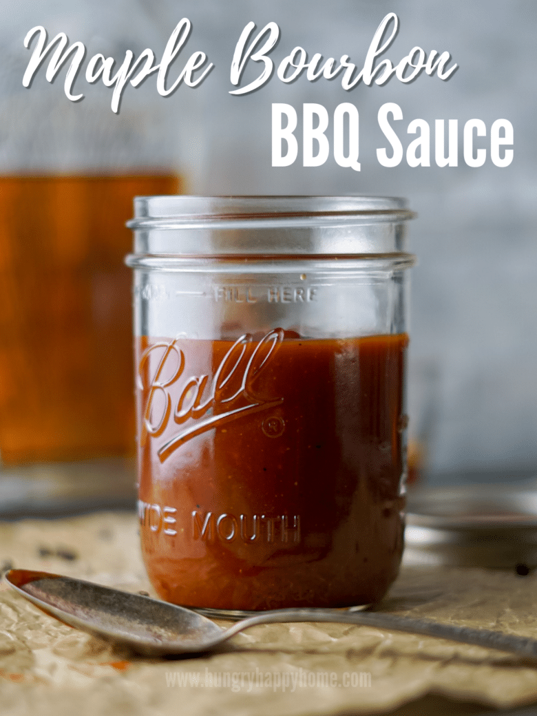 Bourbon Maple BBQ Sauce in a glass mason jar with a antique silver spoon laying in front of it.