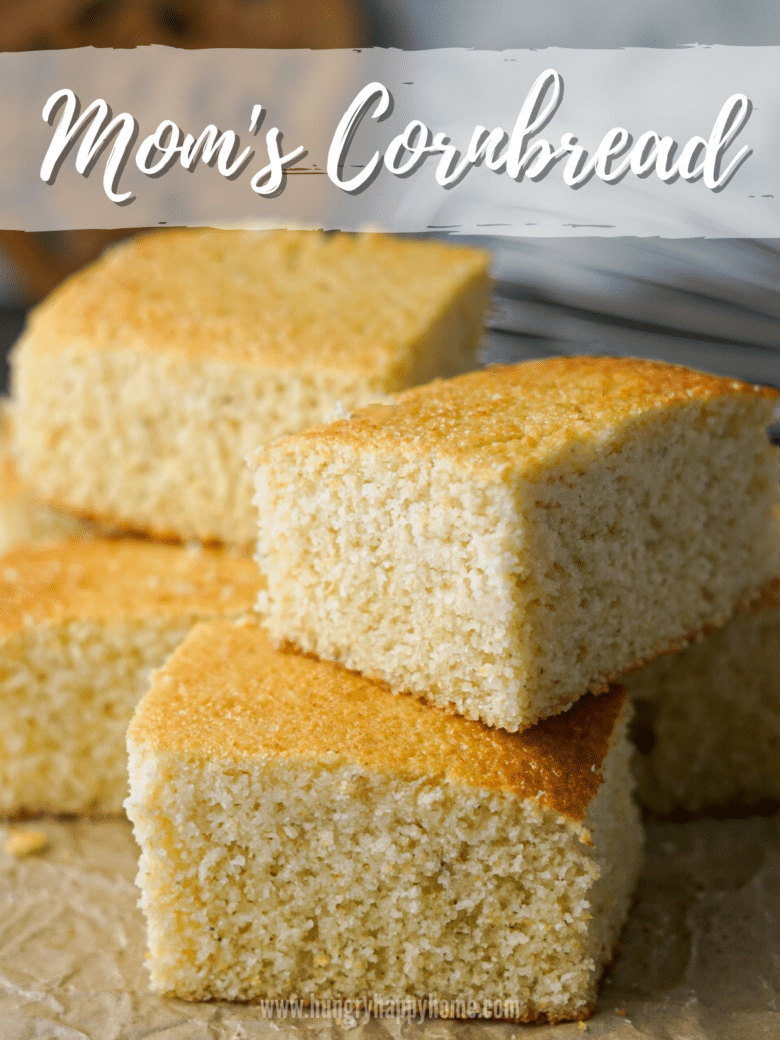 Squares of cornbread stacked on brown parchment paper.