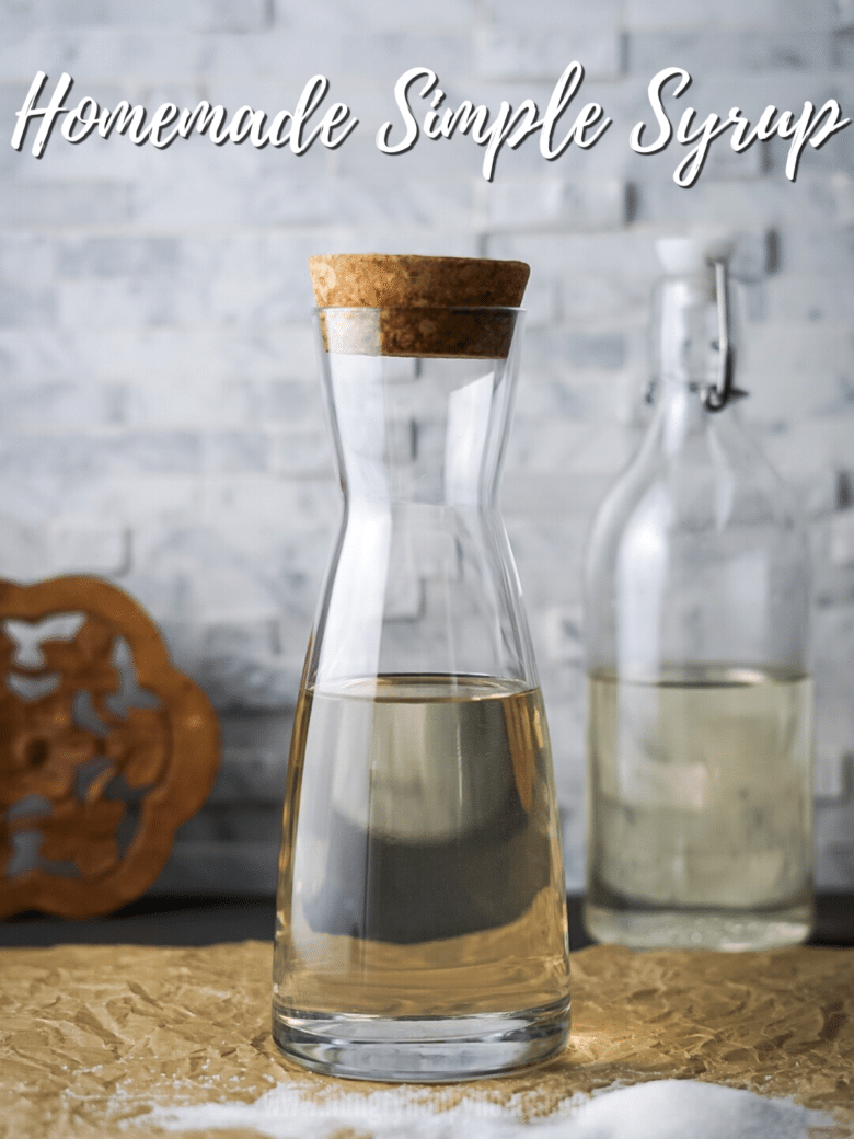 Homemade Simple Syrup in a clear glass bottle with a cork lid.