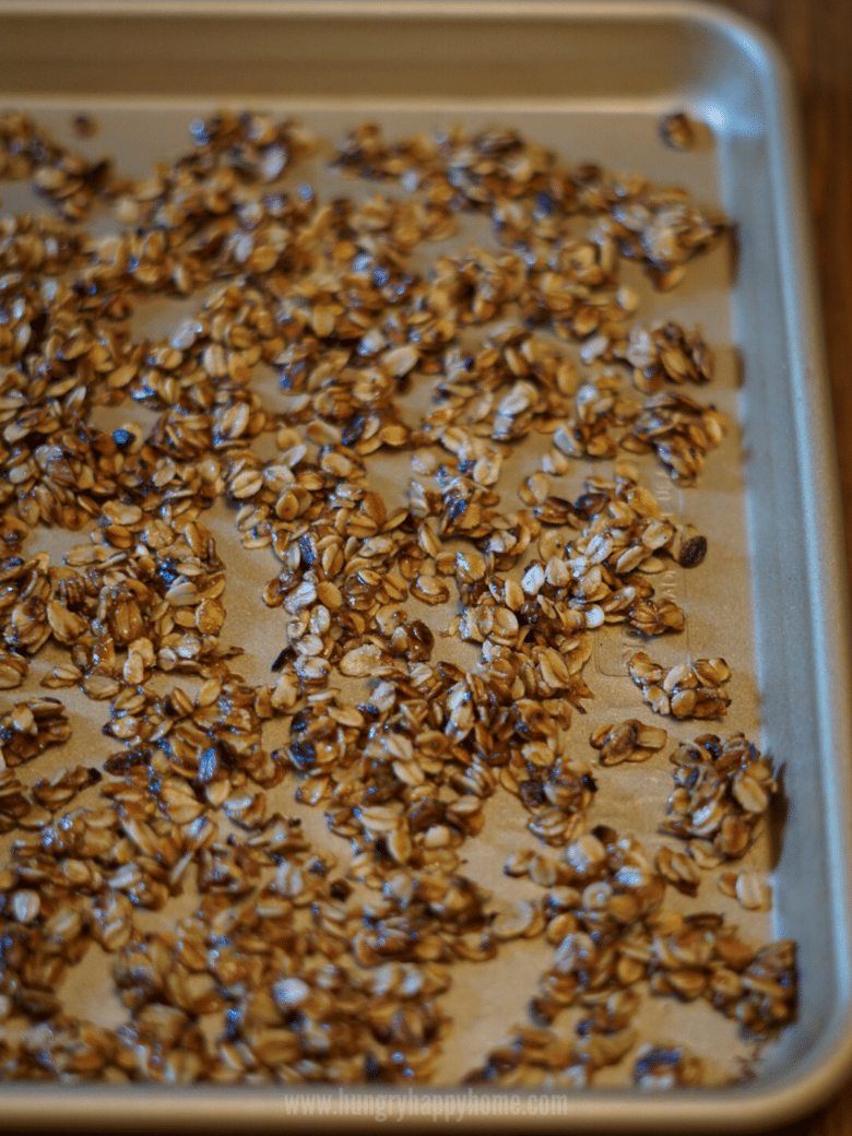 Finished Stove-Top granola spread out on a large baking dish to cool.