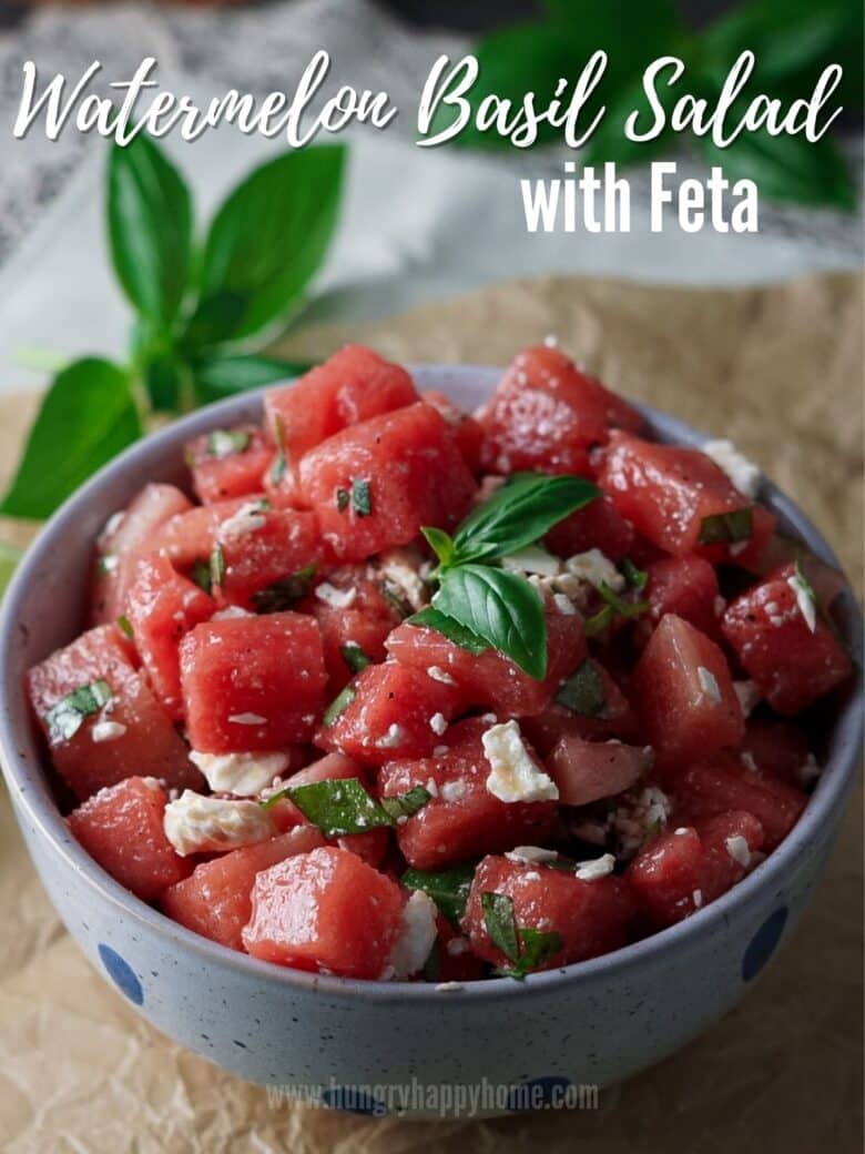 Watermelon Basil Salad with feta in a blue ceramic bowl.